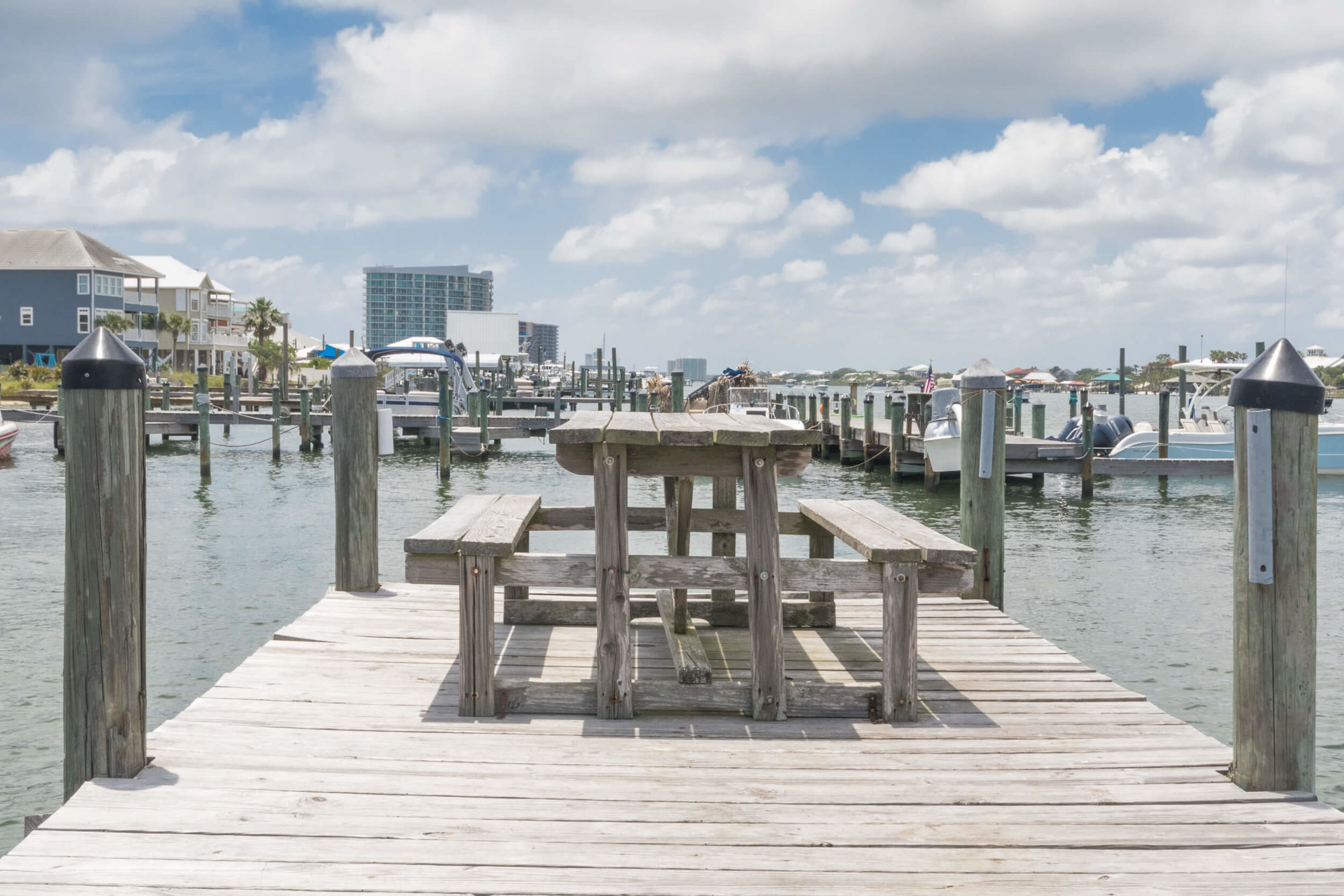 Watch the boats go by sitting on the dockside picnic table at Pescador Landing condos in Perdido Key